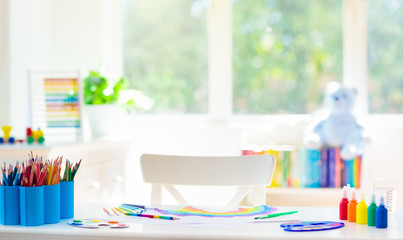 Kids bedroom with wooden, paint and art supplies.