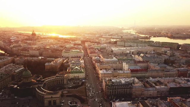 Aerial spring sunset view of Saint Petersburg Nevsky prospect Kazan cathedral Kazanskiy Kafedralniy Sobor Singer House of the Book Neva river roofs road cars rooftops famous place of Russia religion