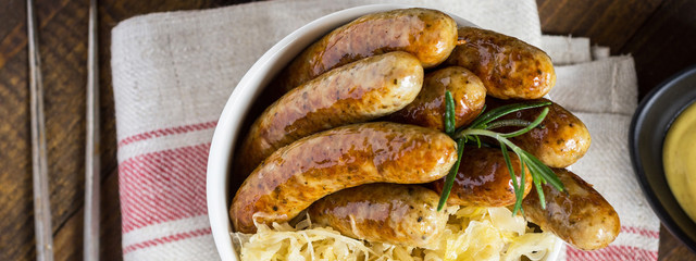 Traditional German Sausages with Cabbage Salad, Mustard and Beer. Bratwurst and Sauerkraut.