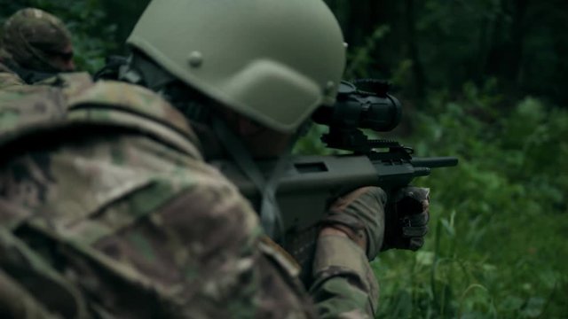 A fully equipped soldier took up a firing position. Fighting. Shooting.