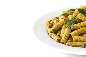 Penne pasta with pesto sauce and basil on a plate isolated on white background