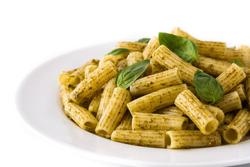 Penne pasta with pesto sauce and basil on a plate isolated on white background
