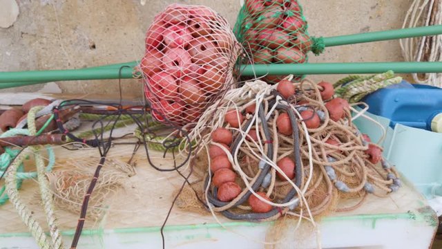 Reti e galleggianti per la pesca di fianco la barca prima della partenza del pescatore.