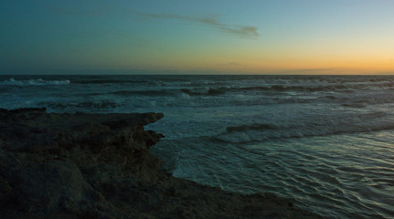 sunset sea rocks waves water