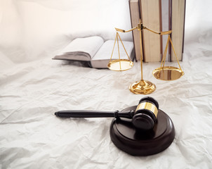 The wooden judge gavel and soundboard put beside gold brass Scale and book stacked,Hammer of...