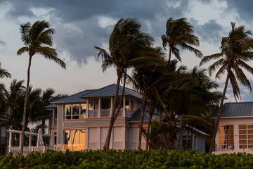Coast house beachfront waterfront vacation home, house during evening sunset with nobody in...