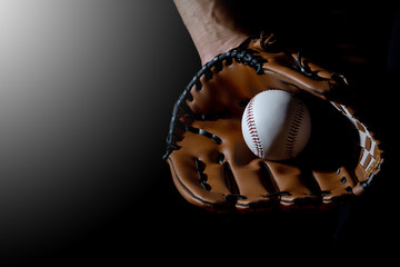 Baseball glove hand holding a baseball