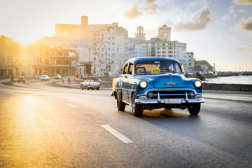 Blue car in Cuba's sunset
