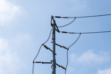 Electric pole with glass insulators against clear sky