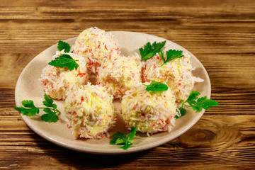 Appetizer of crab-cheese balls on wooden table