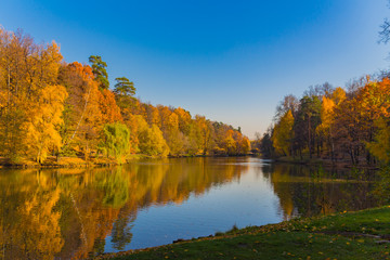 Scenic view to the autumn park and pond