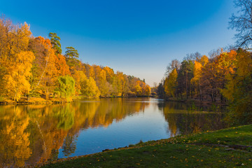 Scenic view to the autumn park and pond