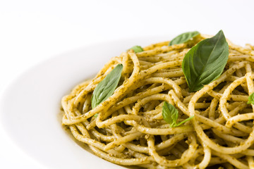 Spaghetti pasta with pesto sauce isolated on white background.