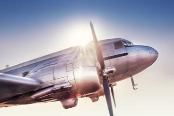 historical aircraft against a sunset