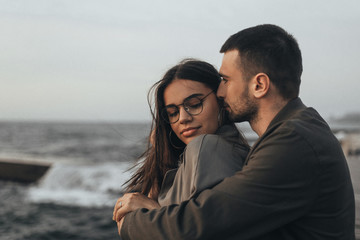 Fototapeta premium Beautiful loving couple walking at sunset, authentic love