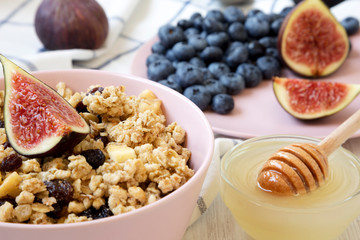 Fruit granola with fruits and honey ready to eat, low angle view. Close-up.