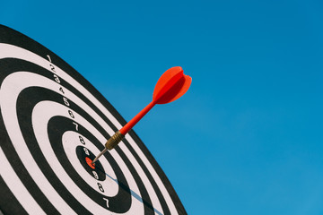 Target dart and arrow with abstract nature bokeh blur background