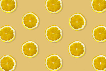 Creative pattern made of lemon. top view of fruit fresh limes slices on orange & yellow colorful background.
