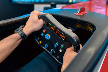 Man playing a racing video game - driving f1 simulator