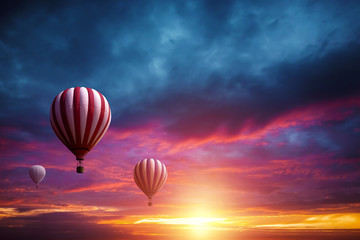 Multicolored, large balloons in the sky against the backdrop of a beautiful sunset. Concept of...