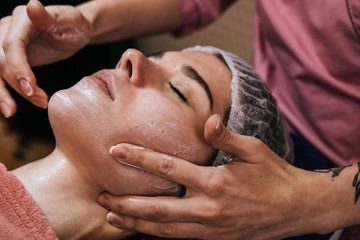  The woman gets a facial massage at the spa