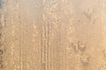 Frost in window at warm sunlight defocused