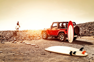 Red summer car on beach and free space for your decoration. Sunset time and surfer.  © magdal3na