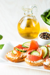 Tomato and cheese fresh made bruschetta. Italian tapas, antipasti with vegetables, herbs and oil on grilled ciabatta and baguette bread. Sandwich.
