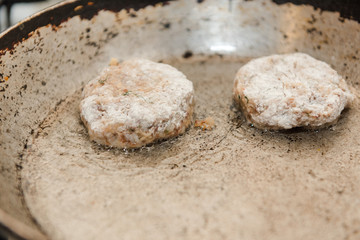 Cutlets are roasted in an old frying pan. Buckwheat cutlets. Buckwheat cutlets are fried. Veggie cutlets. natural food.