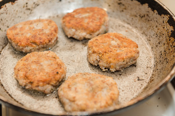 Cutlets are roasted in an old frying pan. Buckwheat cutlets. Buckwheat cutlets are fried. Veggie cutlets. natural food.