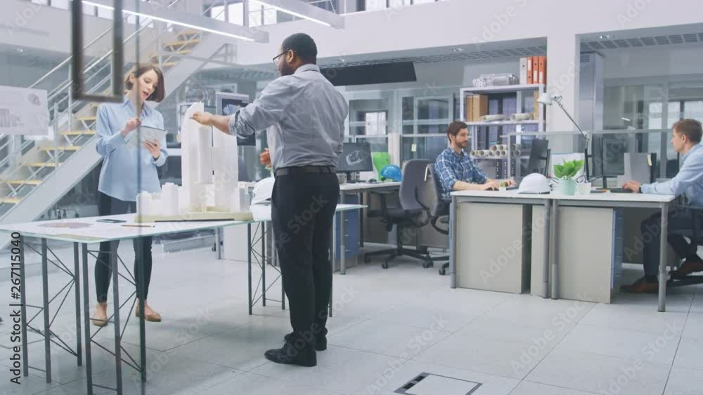 Poster in architectural bureau: architect and engineer talking, working on a building complex prototype pro