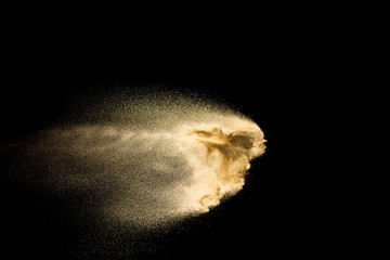 Brown dry river sand explosion isolated on black background. Abstract sand splash.