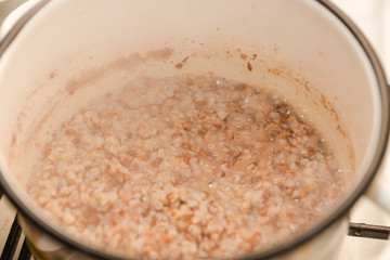 Boil buckwheat. Buckwheat stew in a saucepan. Homemade food. Homemade cooking buckwheat.