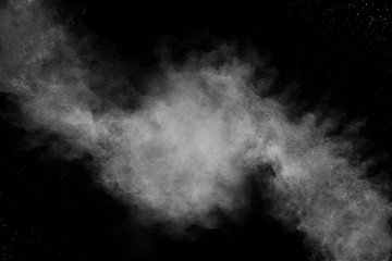 Bizarre forms of white powder explosion cloud against black background.White dust particles splash.
