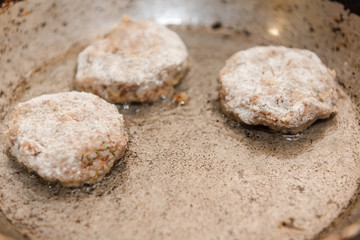 Cutlets are roasted in an old frying pan. Buckwheat cutlets. Buckwheat cutlets are fried. Veggie cutlets. natural food.