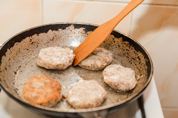 Cutlets are roasted in an old frying pan. Buckwheat cutlets. Buckwheat cutlets are fried. Veggie cutlets. natural food.