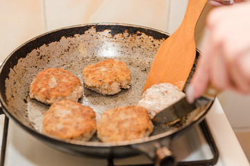 Cutlets are roasted in an old frying pan. Buckwheat cutlets. Buckwheat cutlets are fried. Veggie cutlets. natural food.