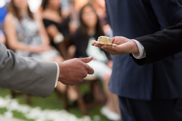 groom holding wedding coins box
