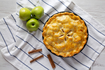 Homemade apple pie on cloth, overhead view. Flat lay, top view, from above.