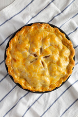 Homemade apple pie on cloth, overhead view. Flat lay, top view, from above. Close-up.