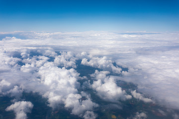 Obraz na płótnie Canvas Earth in the airplane window with clouds