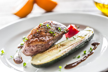 Roasted duck breast with zucchini tomato and parsley herbs