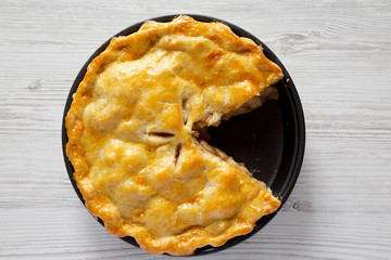 Homemade apple pie on a white wooden background, top view. Flat lay, overhead, from above.