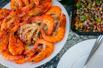 Fresh grilled shrimps, octopus on the dish and beans salad.
