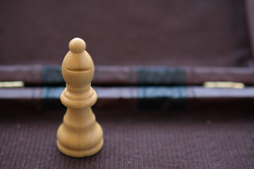 White, wooden chess bishop piece in a vintage box