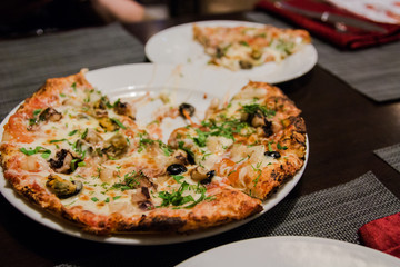 Pizza with seafood with melted cheese and herbs sprinkled on top