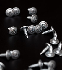 Sharp screws on a black background