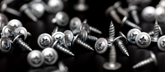 Sharp screws on a black background
