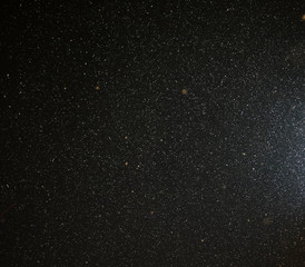 Snow flies in the sky at night as a background