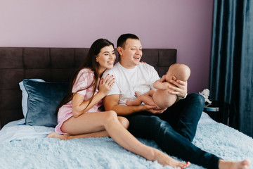 Portrait of a happy young family with a little baby boy.